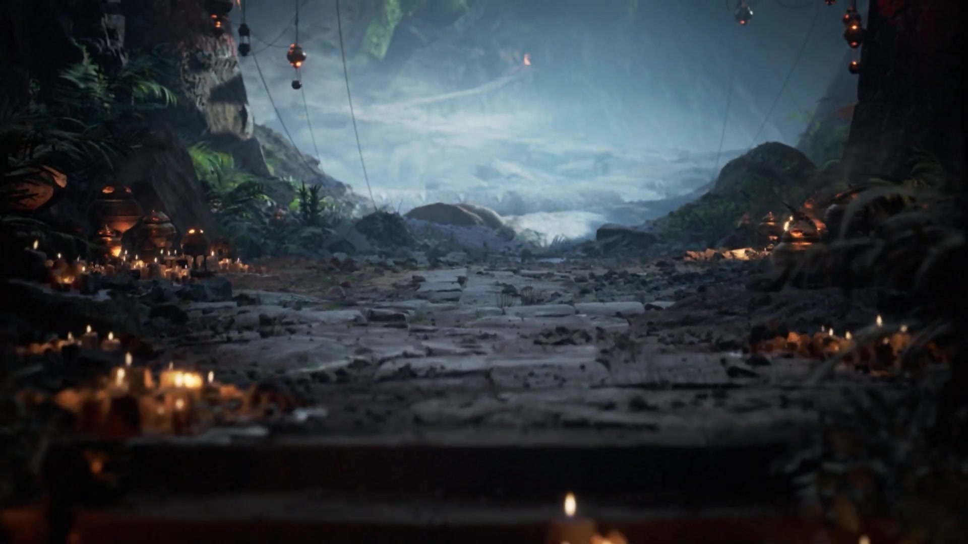 Candlelit stone steps leading towards a cool, misty cavern opening